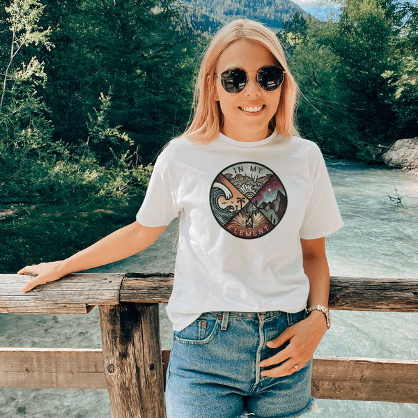 The In My Element t-shirt features a striking circular graphic representing the four classical elements—Fire, Water, Wind, and Earth.